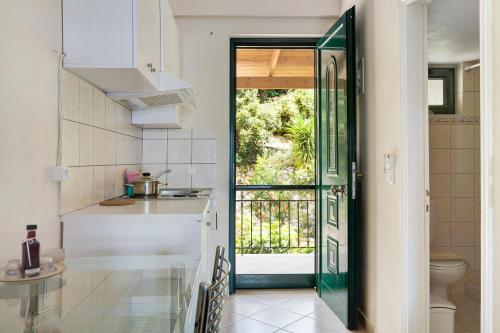 a kitchen with a door leading to a bathroom at Vardia studio A in Mikros Gialos