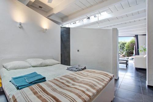 a bedroom with a bed with a blanket on it at La Bodeguita House in Haría