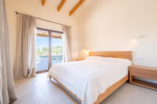 a bedroom with a bed and a balcony at Villa Lorena in Islas Baleares