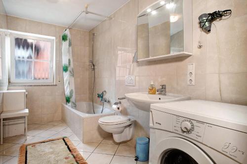 a bathroom with a sink and a toilet and a sink at Ferienwohnungen Shamal in Reutin