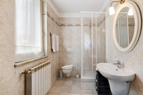 a bathroom with a sink and a toilet and a mirror at Maison Noris in Finale Ligure