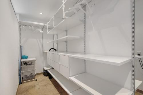 a white closet with white shelves in it at Ferienwohnung Schneider in Blaubeuren