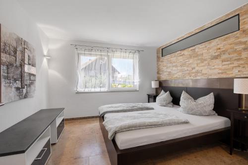 a bedroom with a large bed and a desk at Ferienwohnung Schneider in Blaubeuren