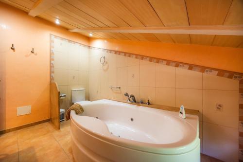 a bath tub in a bathroom with a toilet at Can Gallot De Punxuat - Pool in Algaida