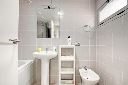 a white bathroom with a sink and a toilet at Albalat Tarongers in Albalat de Taronchers