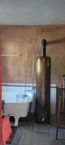a bath tub in a bathroom with a water fountain at Historisches Bahnwärterhaus in Gremmelsbach