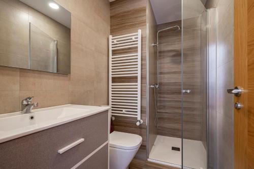a bathroom with a toilet and a sink and a shower at 4 Jardin- Puerto Chico in Llanes
