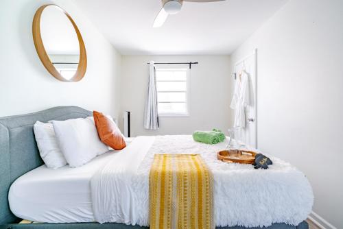a bedroom with a large bed with a mirror on the wall at Jungle House Modern Lofts - Arena District & Short North in Columbus