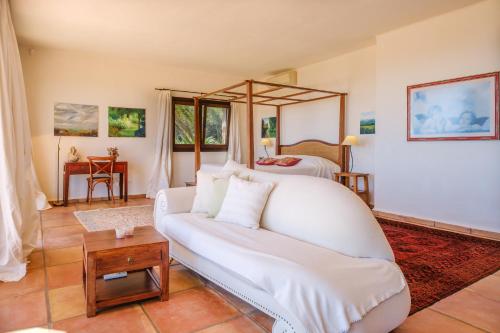 a living room with a couch and a bed at Sa Muntanya panorama in Santa Eularia des Riu