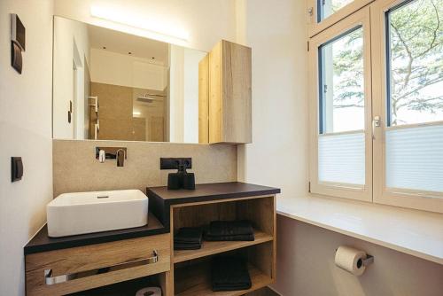 a bathroom with a sink and a mirror at Freienfeldhof Gala in Lagundo