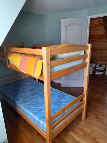 a bunk bed in a room with a staircase at La Maisonnette in Goulles