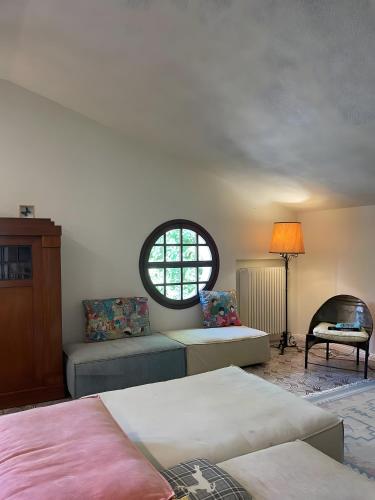 a bedroom with two beds and a window at Villa Gioia sui colli Euganei in Torreglia
