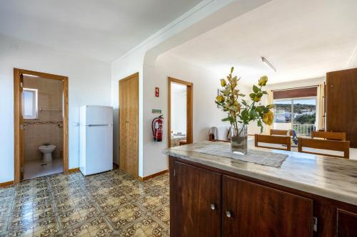 a kitchen with a counter and a refrigerator at Villas Brites nº5 in Burgau