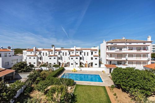 a large white apartment building with a swimming pool at Villas Brites nº5 in Burgau