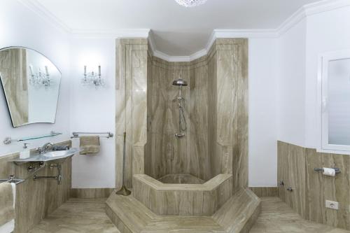a bathroom with a shower and a tub and a sink at Exclusive Villa with Heated Pool in Maspalomas