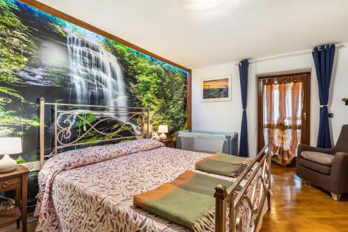 a bedroom with a bed with a large painting on the wall at Lo Sondzo in Nus