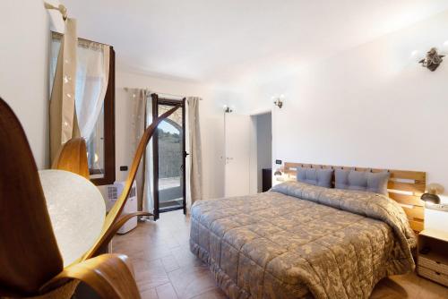 a bedroom with a bed and a table and a window at Baia di Campo in Campomorone