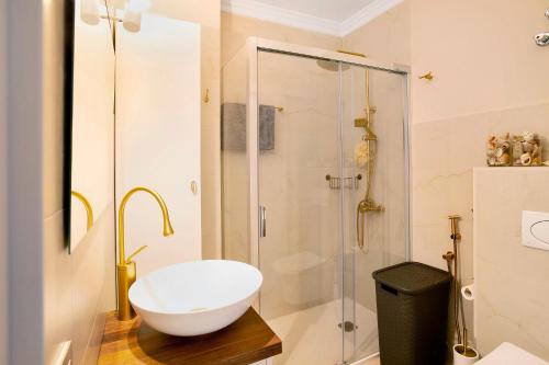 a bathroom with a glass shower and a white sink at Ocean Side Arinaga in Arinaga
