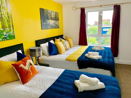 a bedroom with two beds with towels on them at 2 Bedrooms Modern Apartment, Lounge, Full Kitchen, Balcony, 5 minutes Stratford Station in London