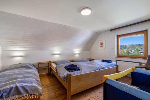 a bedroom with two beds and a window at Haus an der Lauchert in Veringenstadt