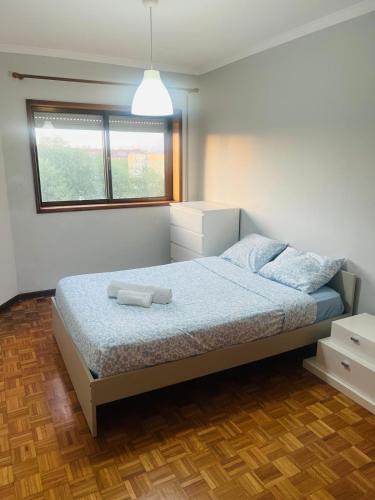 a bedroom with a bed and a window at Stay & Smile Apartment in Póvoa de Varzim