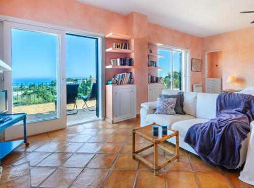 a living room with a couch and large windows at Can Roca in Illes Balears