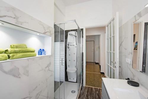 a bathroom with a shower and a sink at Il ciliegio di Miki in Genoa