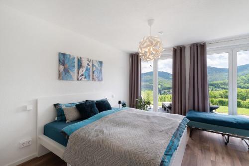 a bedroom with a bed and a large window at Ferienwohnung Luftige Auszeit in Bühlertal