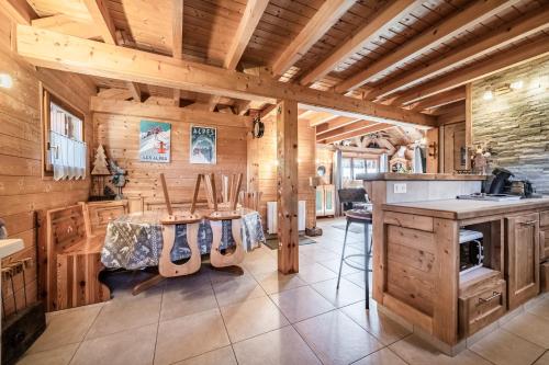 a kitchen with a table with acoustic guitars on it at Chalet 6p Confort - Le bouvreuil in Verchaix