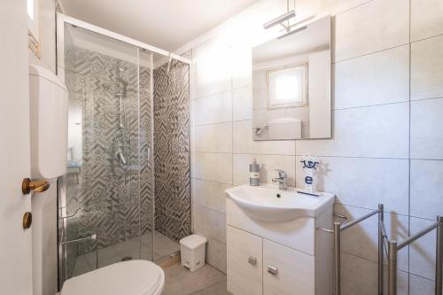 a bathroom with a shower and a sink and a toilet at Elenya Garden Retreat in Torre Lapillo