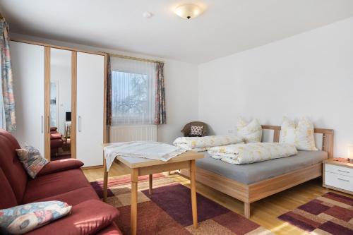 a living room with a couch and a table at Haus Zapf in Kressbronn am Bodensee