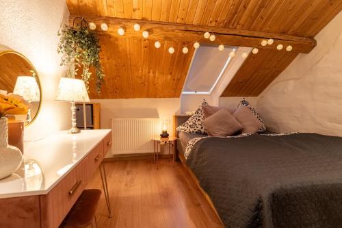 a bedroom with a bed and a dresser and a mirror at Kleines Eifel Backhaus mit Sauna in Feuerscheid