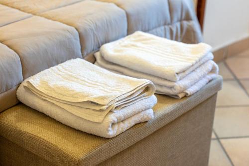 a pile of towels sitting on top of a couch at Dimora La Piana in Ostuni