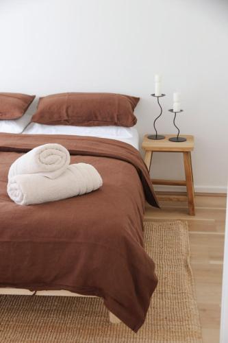 a bedroom with a bed with a white towel on it at Kawa House in Kalbarri