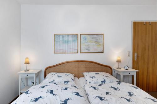 a bedroom with a bed and two night stands at Schönblick in Höchenschwand