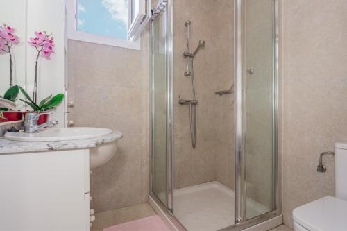 a bathroom with a shower and a sink at Villa Lidia in Cala Galdana