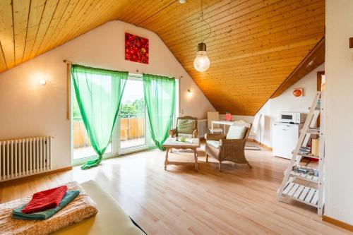 a living room with a large window and a table at Jonagold in Stockach