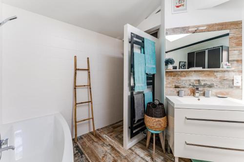 a bathroom with a sink and a mirror at La Villa Sanson in Arcachon
