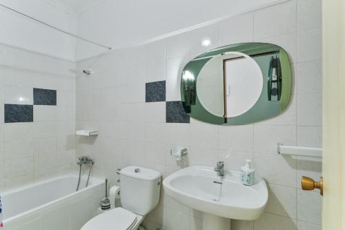 a bathroom with a toilet and a sink and a mirror at Apartamento karla in San Nicolás