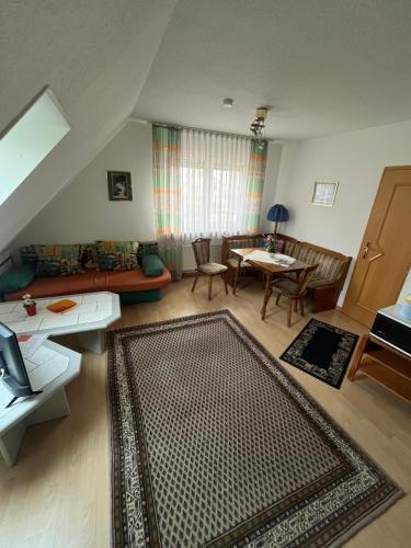 a living room with a couch and a table at Haus Lechner in Cuxhaven