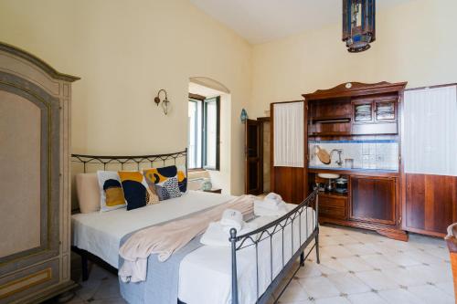 a bedroom with a bed and a dresser in it at Mono Scilla Centro Storico Otranto in Otranto