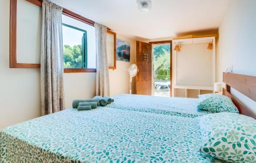 a bedroom with a large bed with a blue bedspread at Cala Deia in Deia