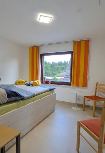 a bedroom with a bed and a large window at Ferienwohnung Gartenblick in Fuhlendorf