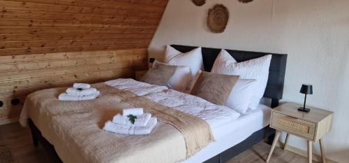 a bedroom with a large bed with towels on it at M B Homes Albstadt in Albstadt