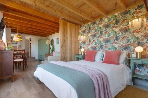 a bedroom with a large bed with a floral wallpaper at Finca la Florida in Icod de los Vinos