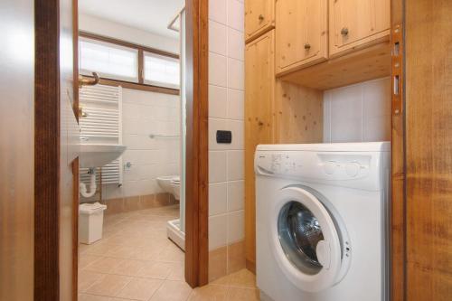 a washing machine in a bathroom with a sink at Residence Larice Bianco App n4 in Campodolcino