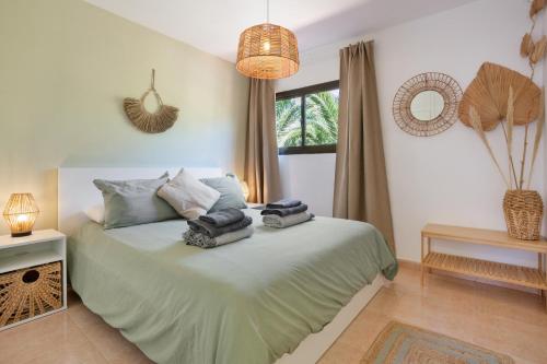 a bedroom with a bed with towels on it at Oasis Duna-Pistacho dreams Pool in Corralejo