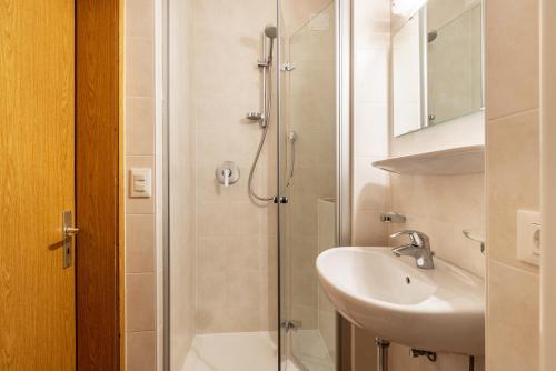 a bathroom with a shower and a sink at Unterhauserhof App C in Valdaora