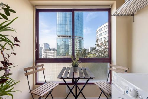 a balcony with a table and two chairs and a window at Destiny Oporto in Maia