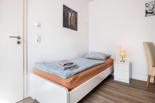 a bed in a room with a white wall at Himmelpforten Loft in Himmelpforten